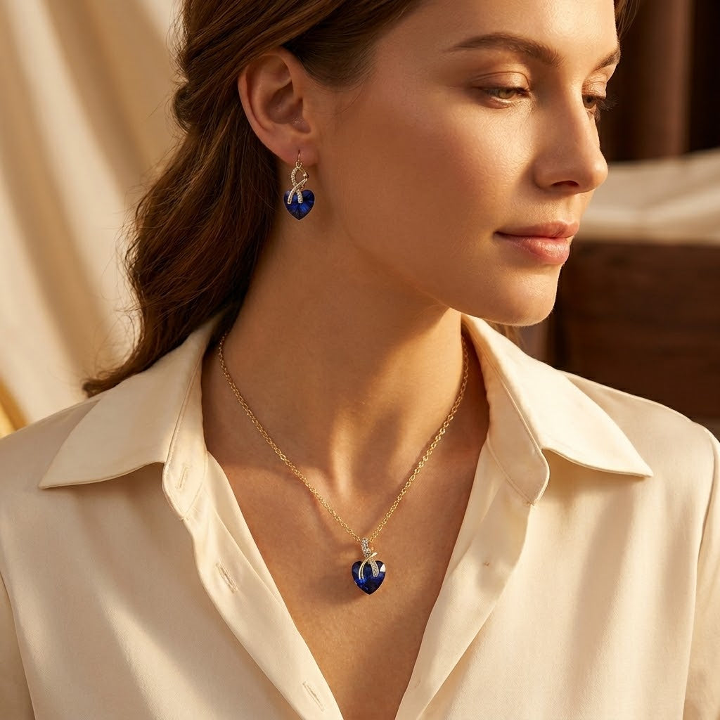 Set van een ketting en oorbellen met een hart van saffier in goud