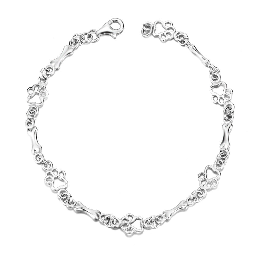 Armband met hondenpoot- en botbedels in zilver