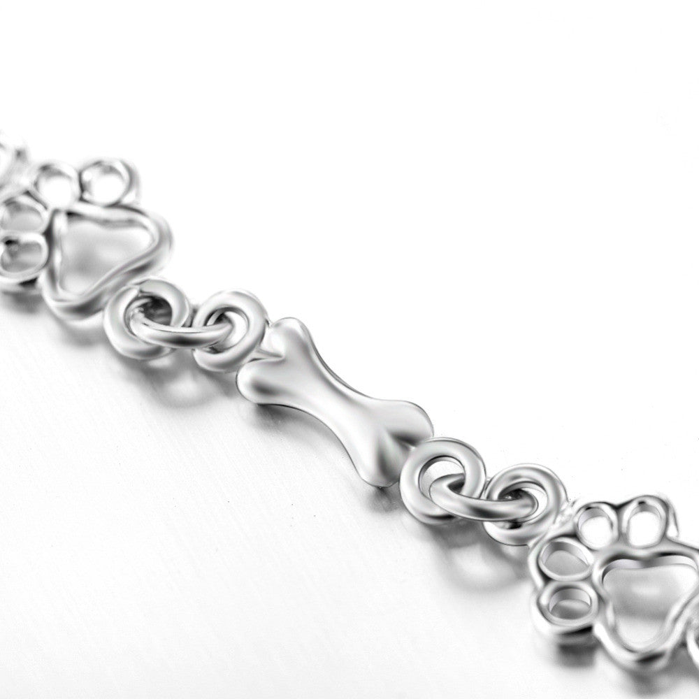 Armband met hondenpoot- en botbedels in zilver