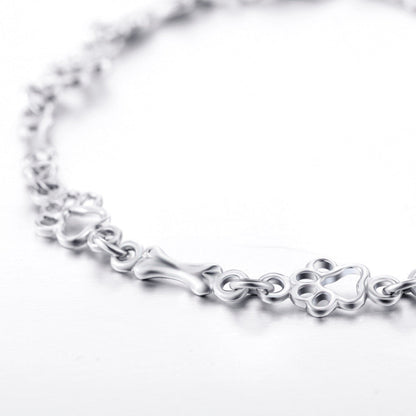 Armband met hondenpoot- en botbedels in zilver