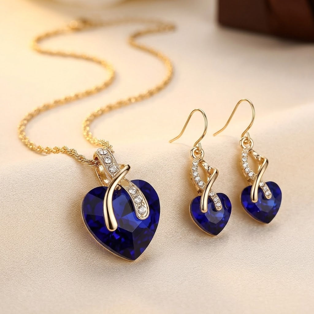Set van een ketting en oorbellen met een hart van saffier in goud